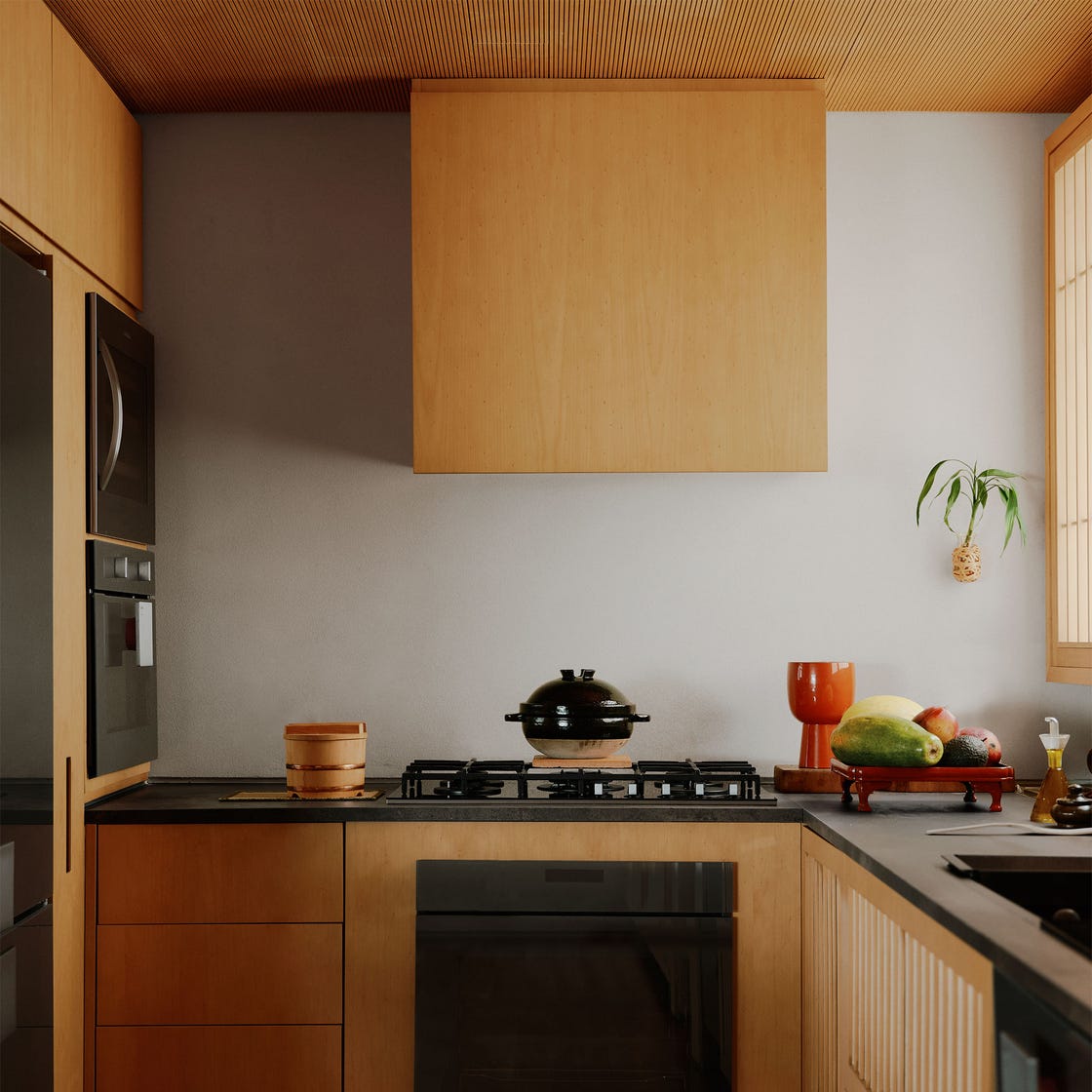 Silvia Furmanovich - Elle Decor Kitchen with wooden cabinets and black worktops and devices, putty -colored wall, covered rice pot on the stove, vegetables on a tray on the counter, wooden flooring, ribbed wooden ceiling