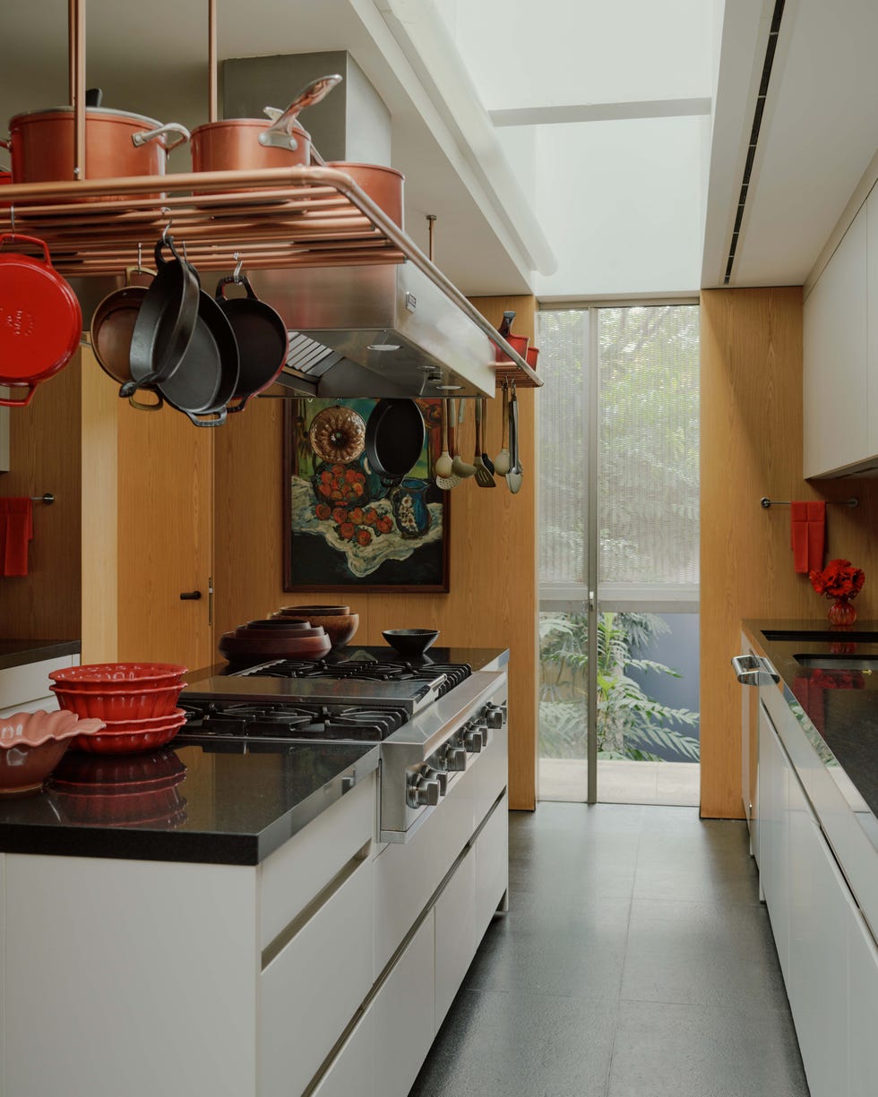 A kitchen with stove and pans A kitchen with stove and pans