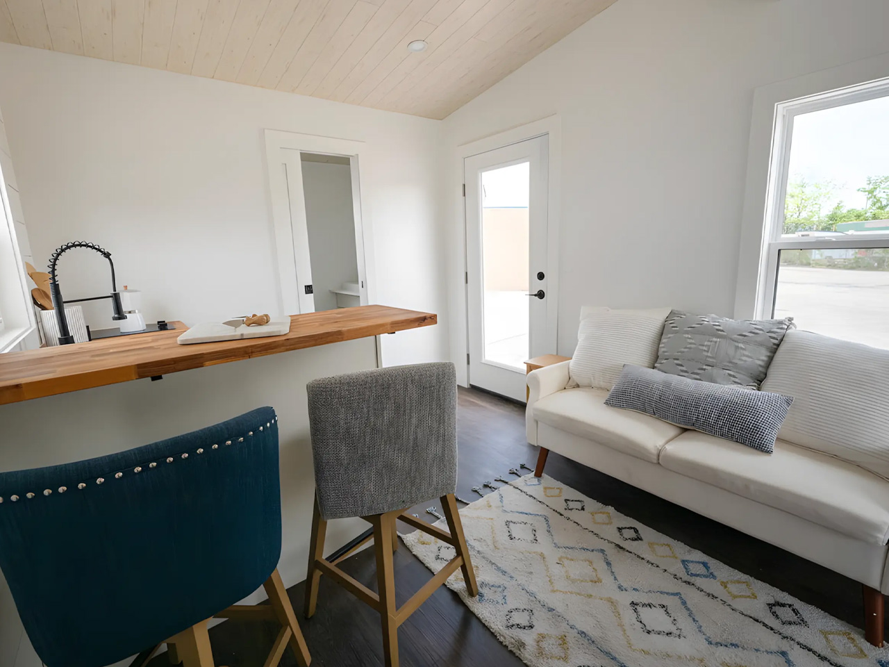 An affordable one -story tiny house offers a spacious interior, modern amenities and nationwide delivery