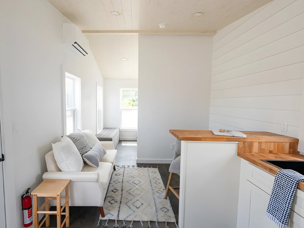 An affordable one -story tiny house offers a spacious interior, modern amenities and nationwide delivery