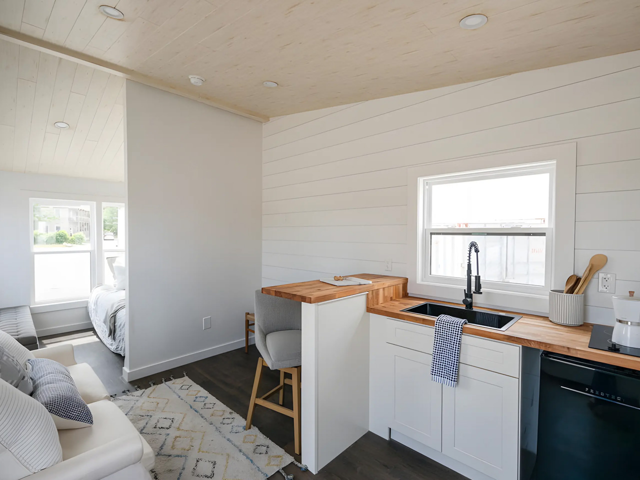 An affordable one -story tiny house offers a spacious interior, modern amenities and nationwide delivery