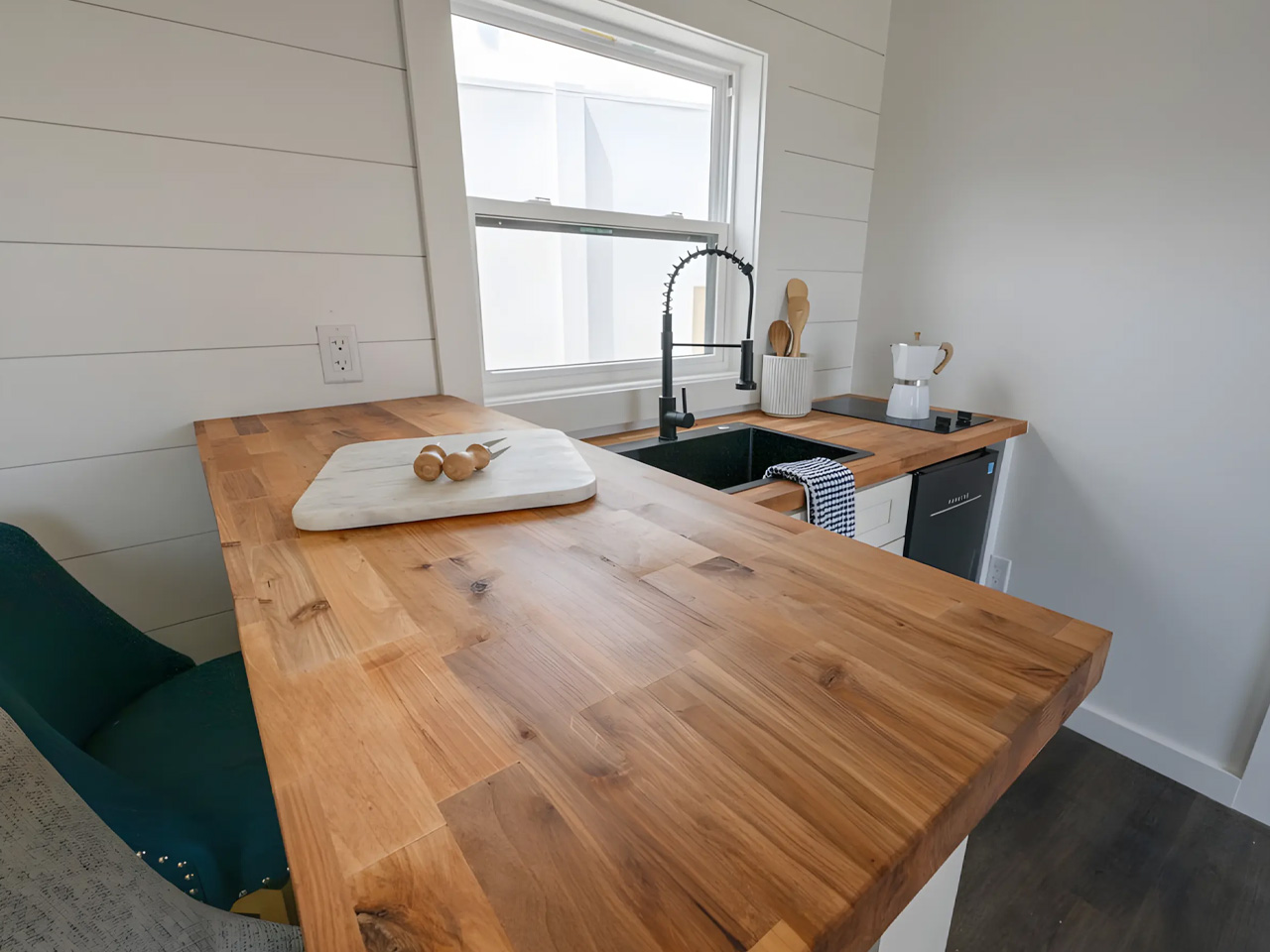 An affordable one -story tiny house offers a spacious interior, modern amenities and nationwide delivery