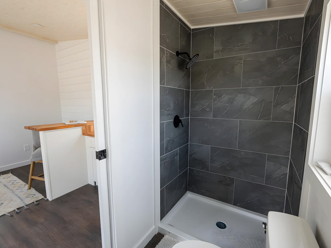 An affordable one -story tiny house offers a spacious interior, modern amenities and nationwide delivery