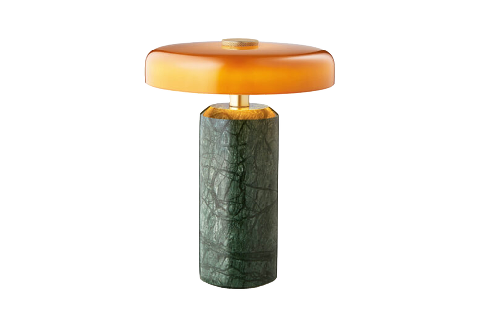 Modern lamp with a rounded amber shadow and a structured green base
