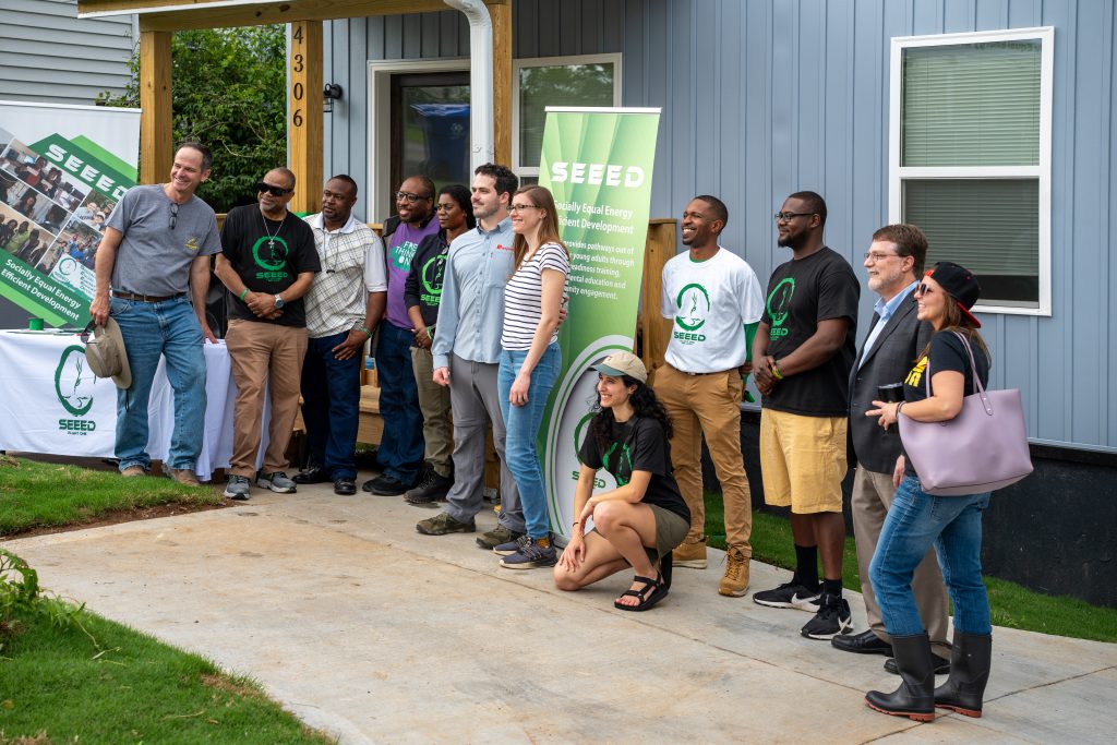 The homeowners Shawn O'Brien and Nicole Yacura at the ribbon ceremony for their home with representatives of Seeed, Ornl and other partners. Photo by Abby Hassler.