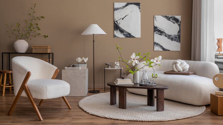 Room with a white bouclé armchair and sofa