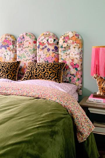 Bed with a floral padded headboard