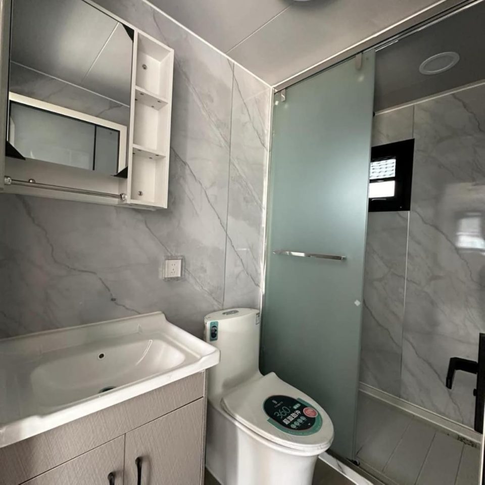 Tiny homeland with sink, toilet and shower.