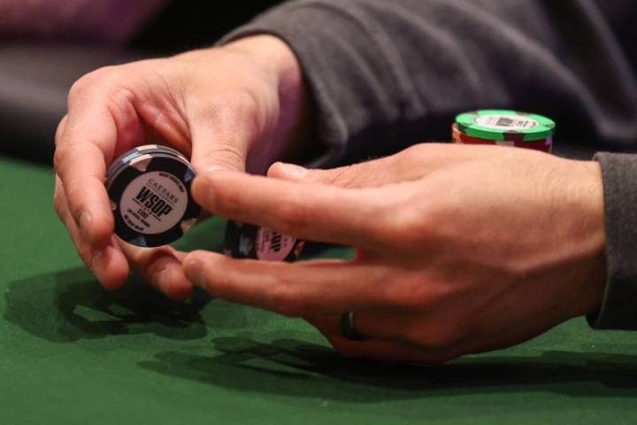 A player fiddles with chips during the World Series of Poker Main Event at the Horseshoe Convention ...