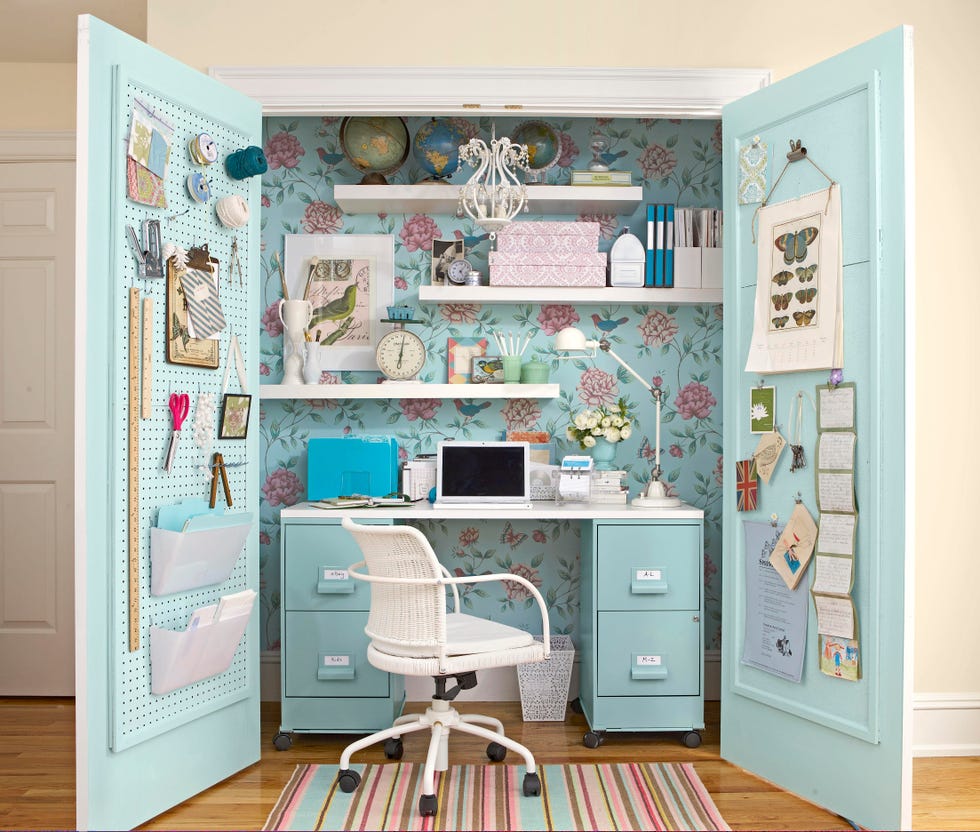Closet was converted into home office with blue color and floral wallpaper