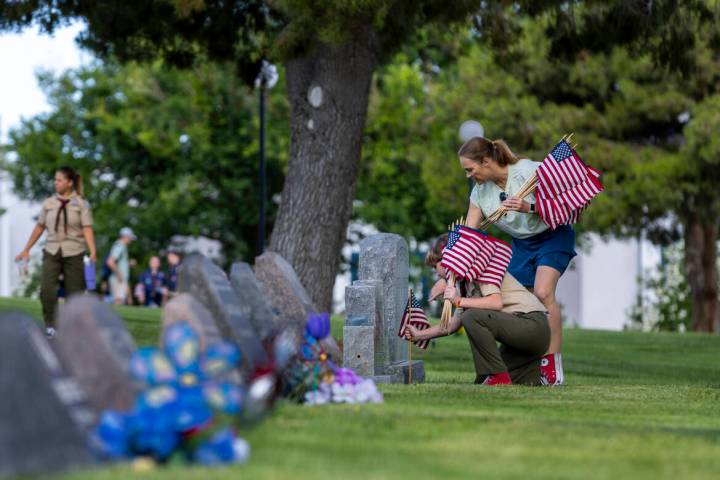 Scouting America's Kit Landman, 12, with Troop #360, and Elizabeth Landman help with the placement ...