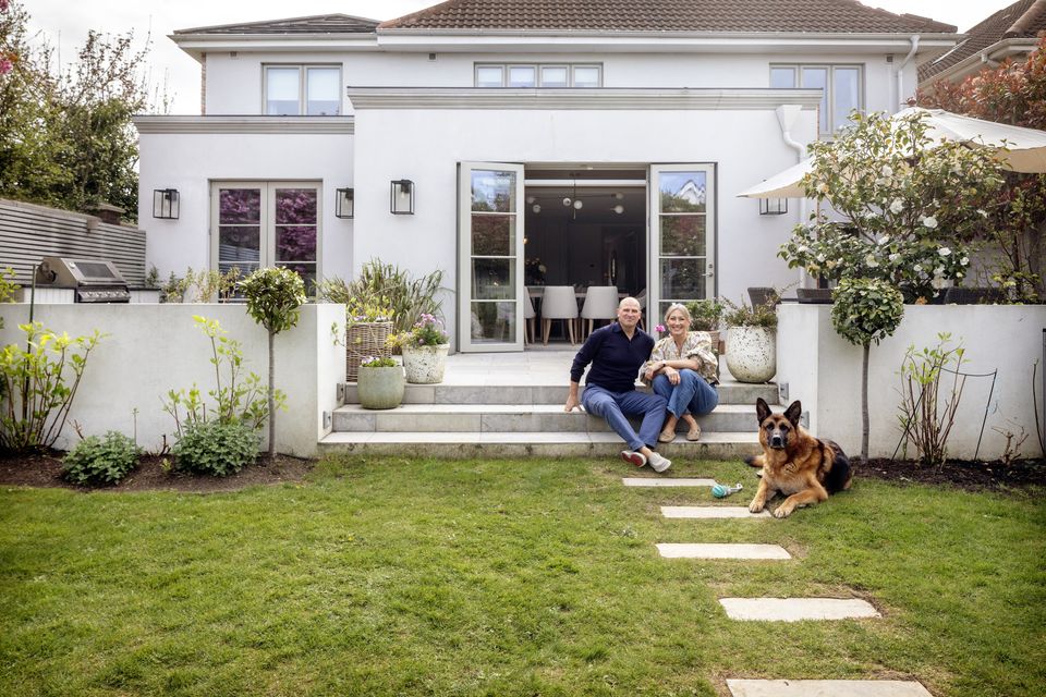 William and Aoife Diamond and her dog Senna in front of her house in Castleknock, Co Dublin. They bought the house in the early Noughties and recently stretched out with the help of Aoife's sister, the interior designer Eilish Rickard. The changes include an expansion, the terrace on which you grill regularly, and the 