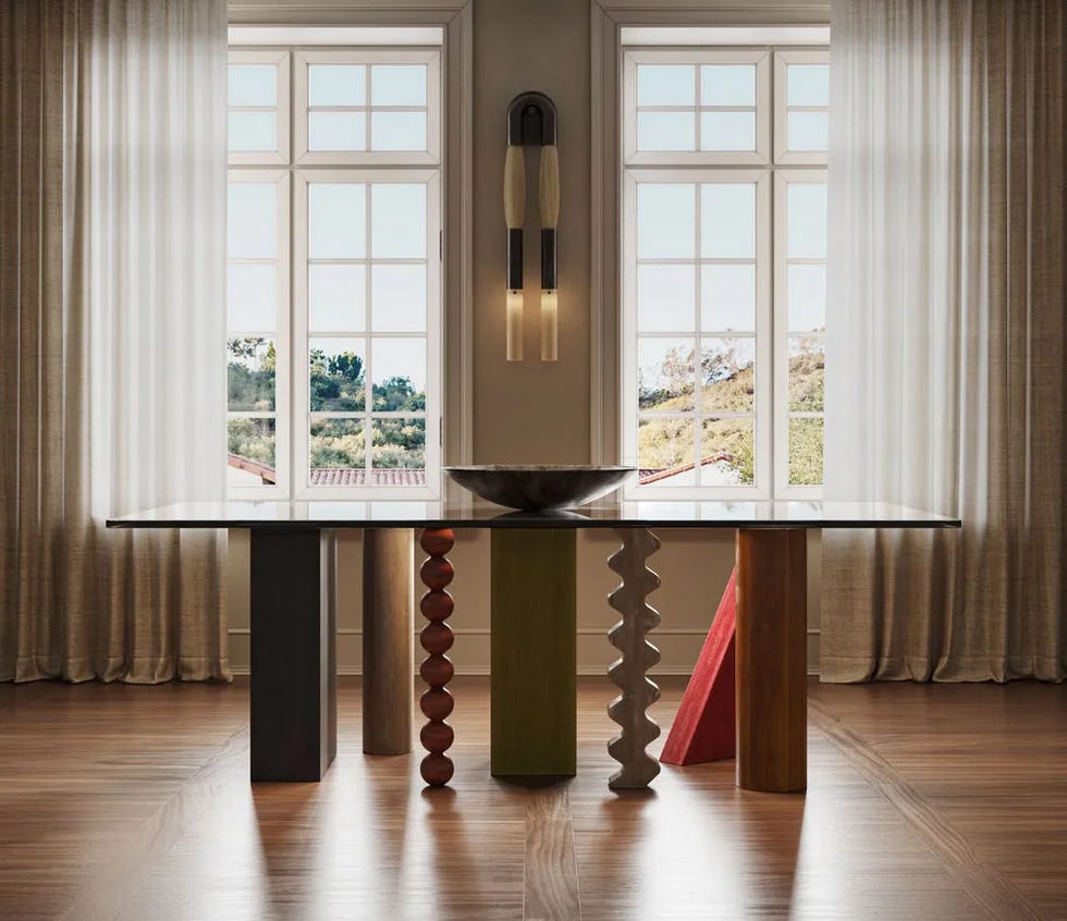 Modern dining table with pronounced geometric legs and shells in the borehole room