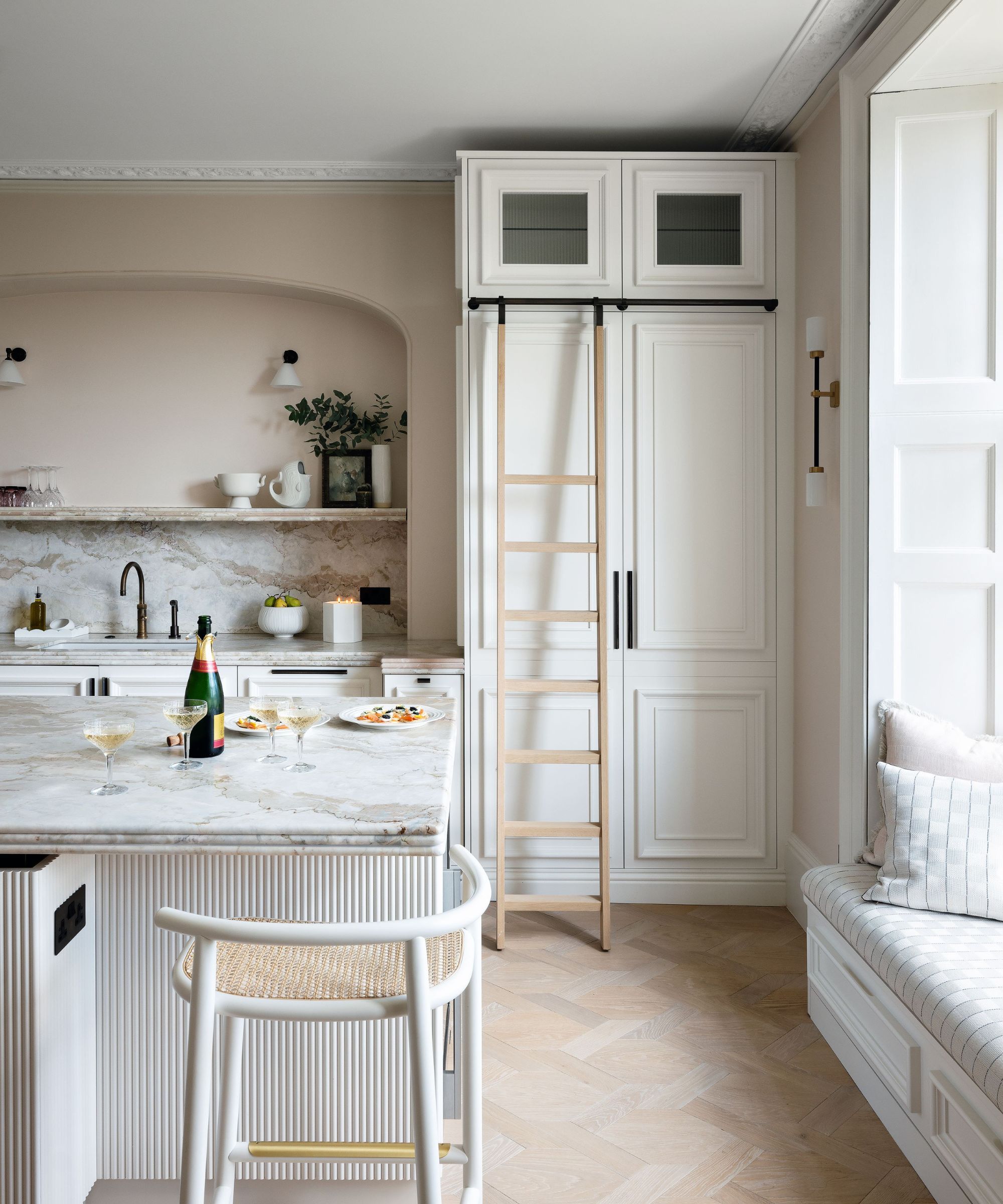 A white kitchen with an island and shelves