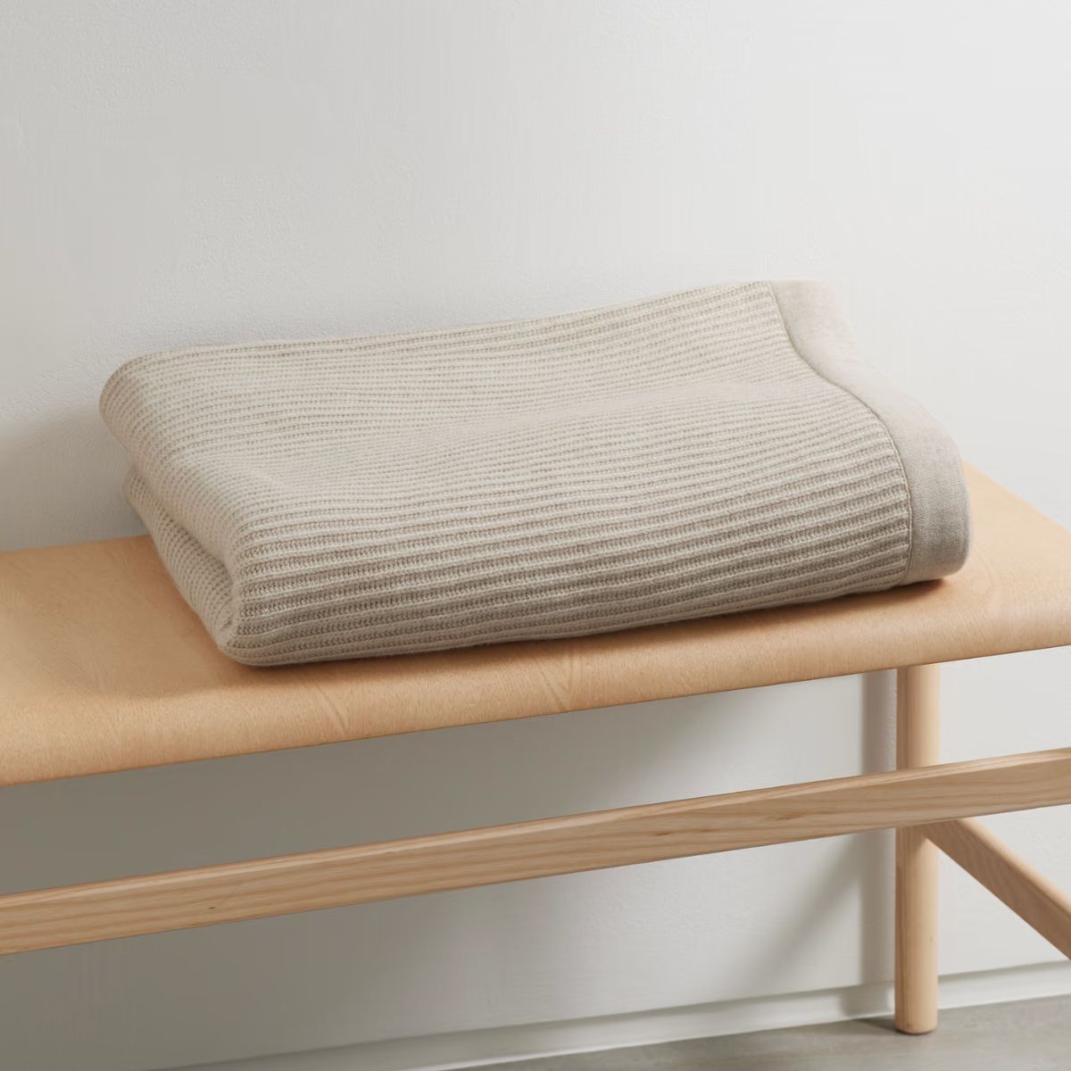 Throw Cream Cashmere on a bench