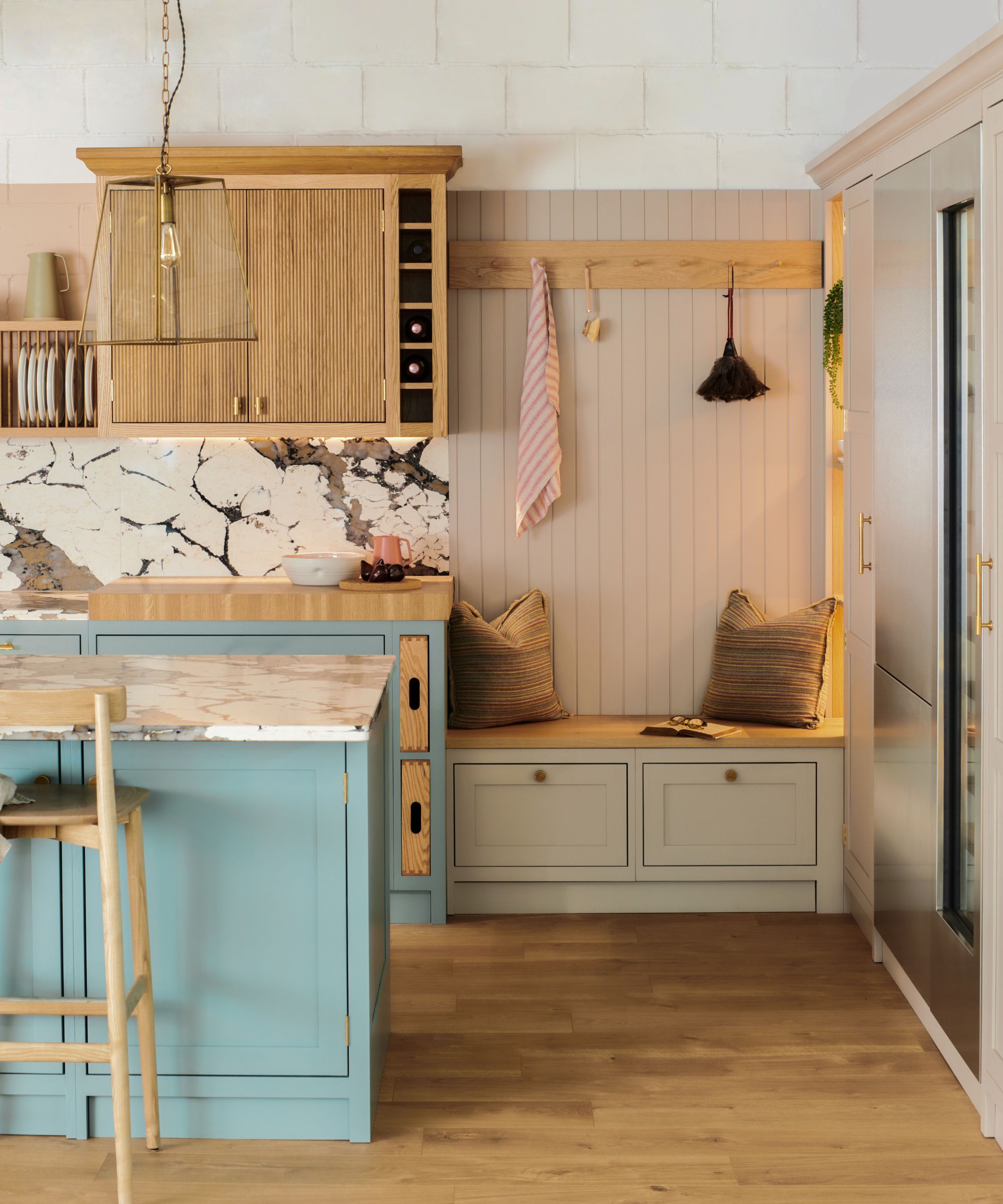 Taupe kitchen cabinets paired with blue cupboards and light wood