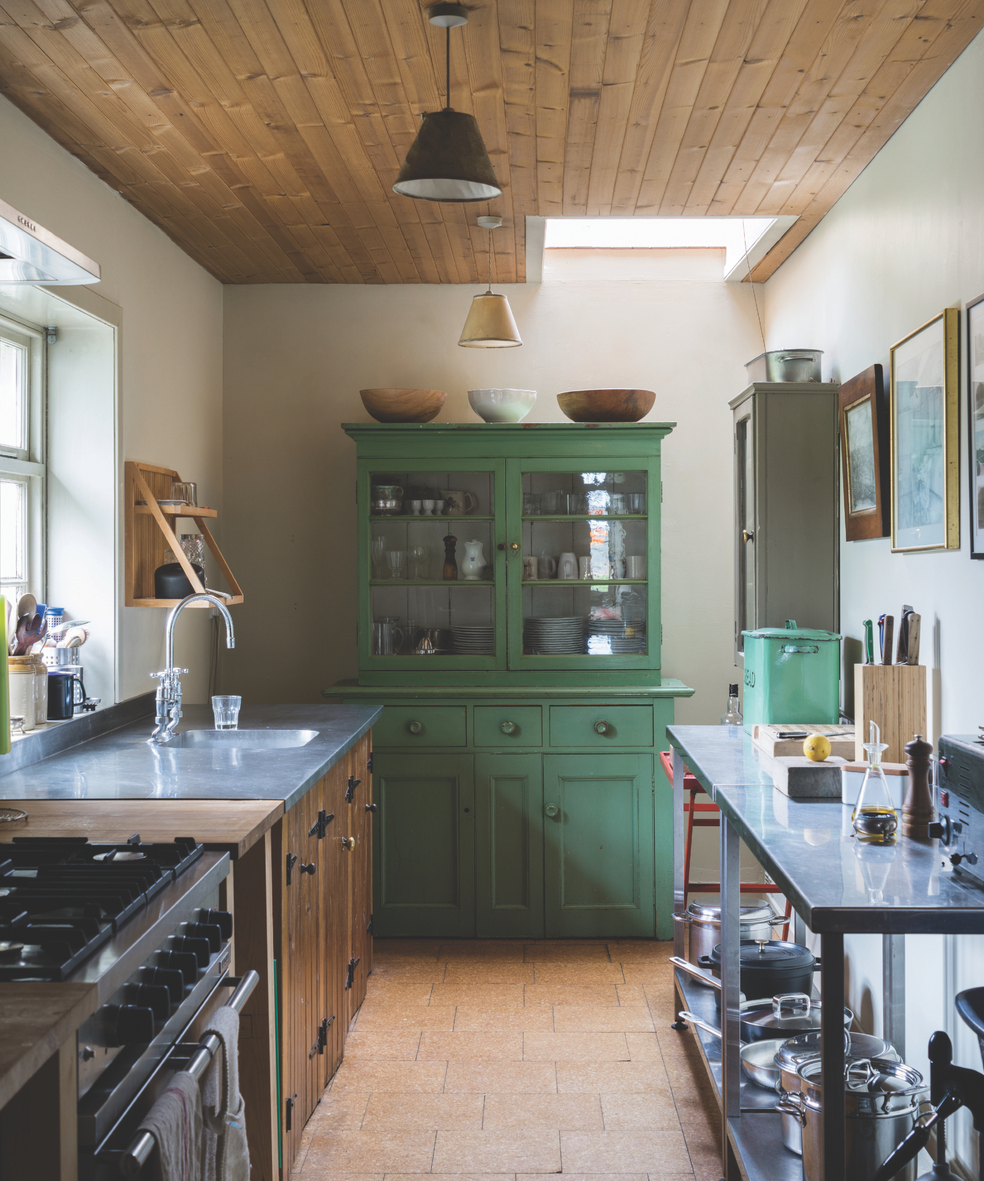 Small kitchen with free -standing cupboards, green painted cabinet with glazed doors, zinc worktops, mere wood Shiplap ceiling, cream walls