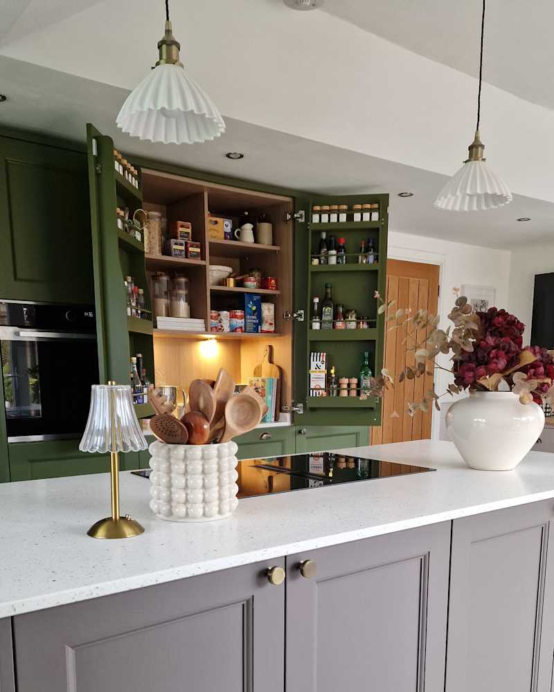 Pendant light hangs over the island in a newly renovated kitchen.