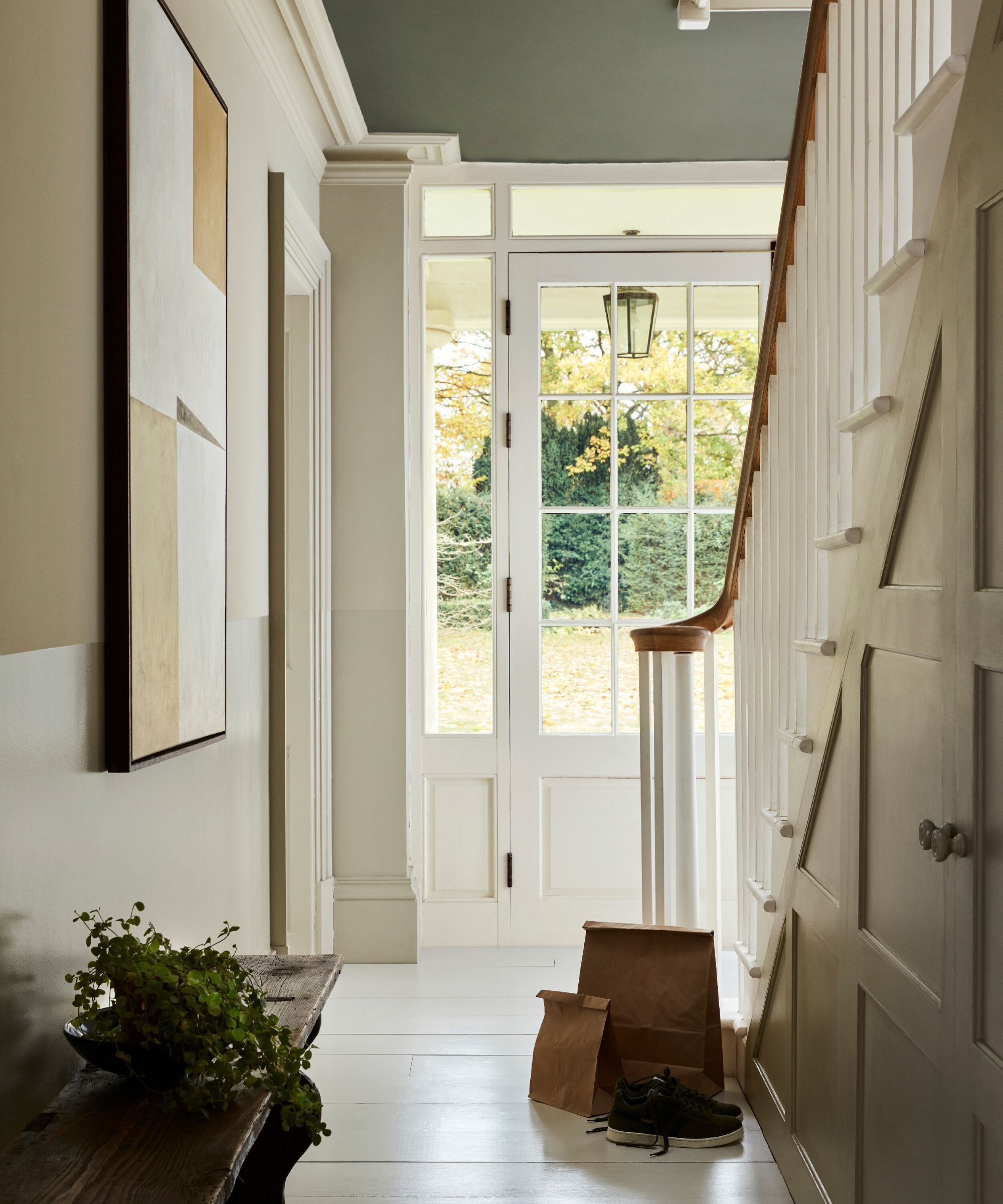 A slightly filled hallway painted in different neutral tones