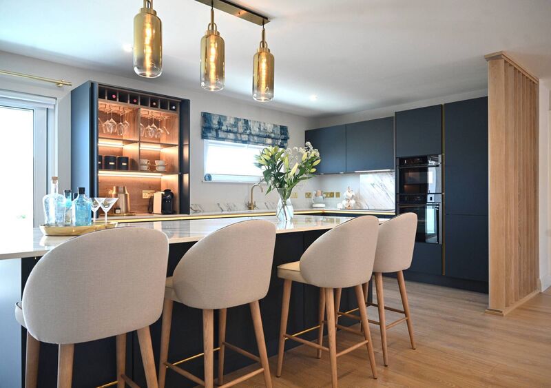 The kitchen has a vertical, solid oak space divider on the right.