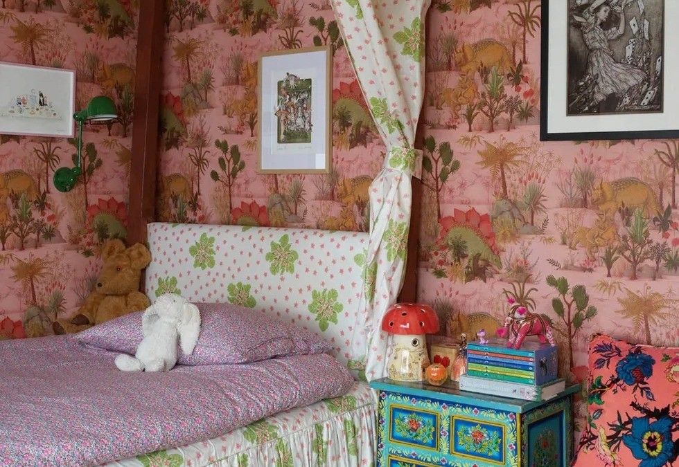 Colorful bedroom with flower patterns, lively wallpaper and versatile decor.