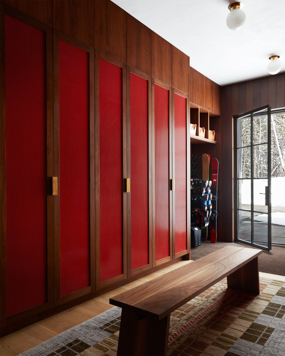 Ski room with red panel wooden bearing and seating
