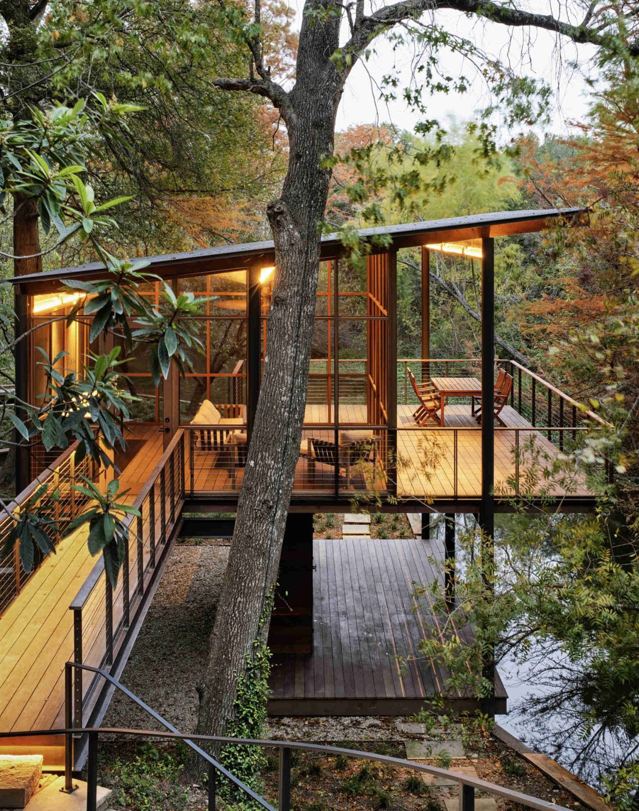 The modern pavilion swims over a stream and offers bird watching and waterfront views