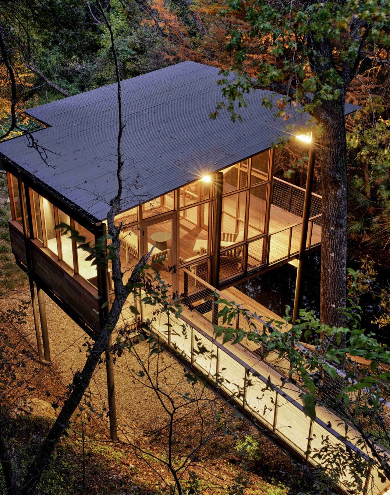 The modern pavilion swims over a stream and offers bird watching and waterfront views