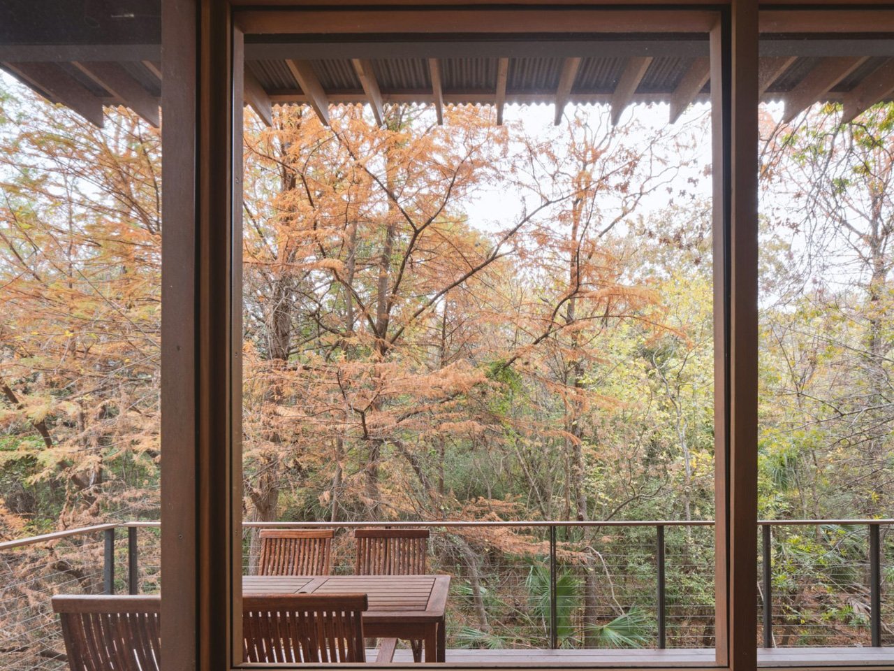 The modern pavilion swims over a stream and offers bird watching and waterfront views