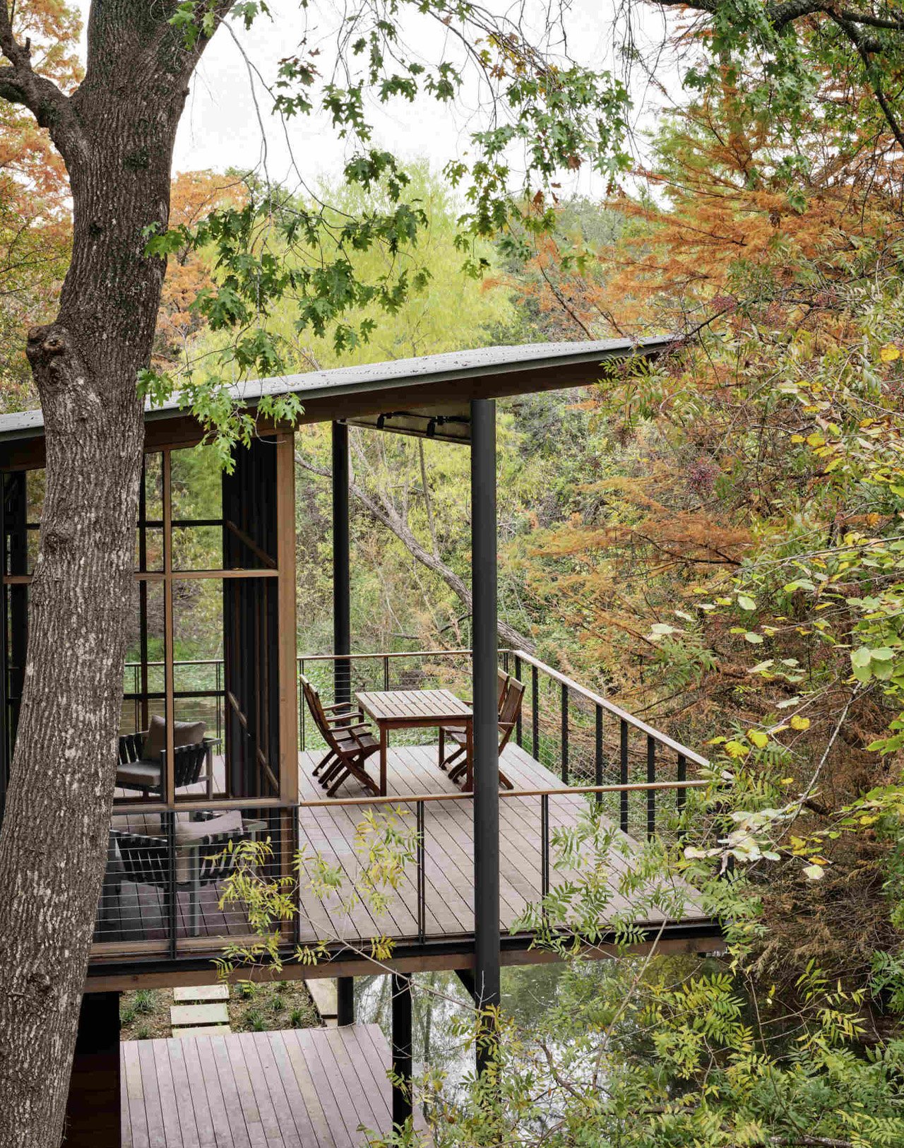 The modern pavilion swims over a stream and offers bird watching and waterfront views