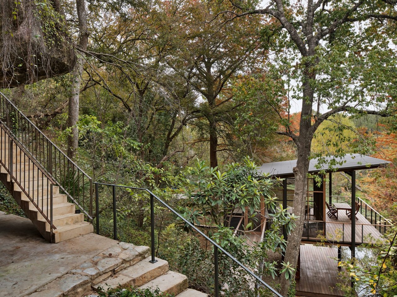 The modern pavilion swims over a stream and offers bird watching and waterfront views