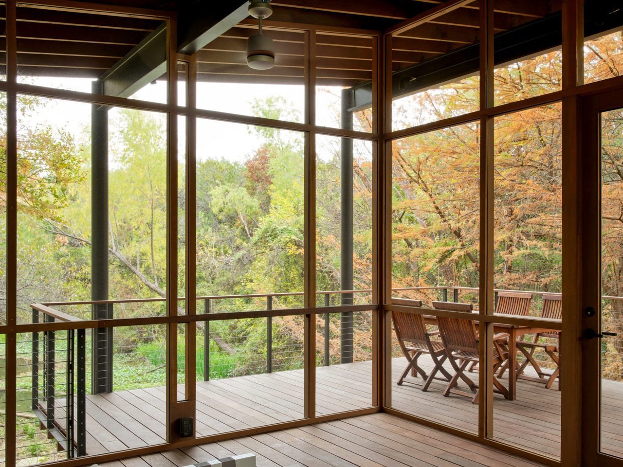 The modern pavilion swims over a stream and offers bird watching and waterfront views