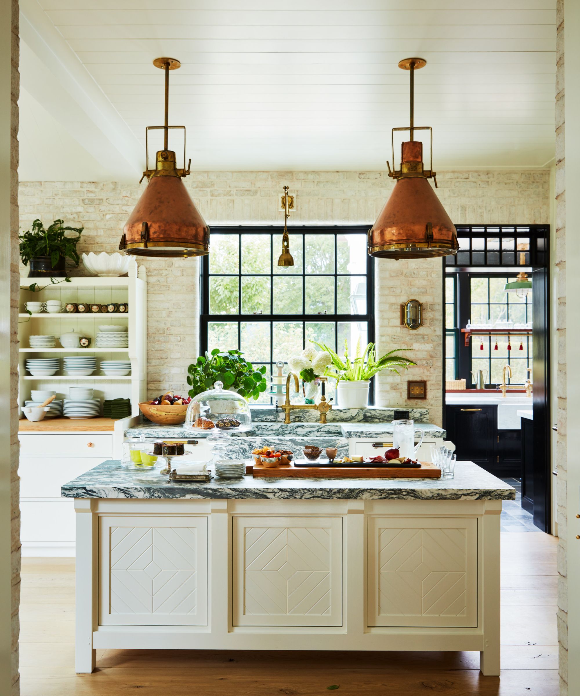 Bryan Graybill's kitchen with copper heating lights over a kitchen island with marble