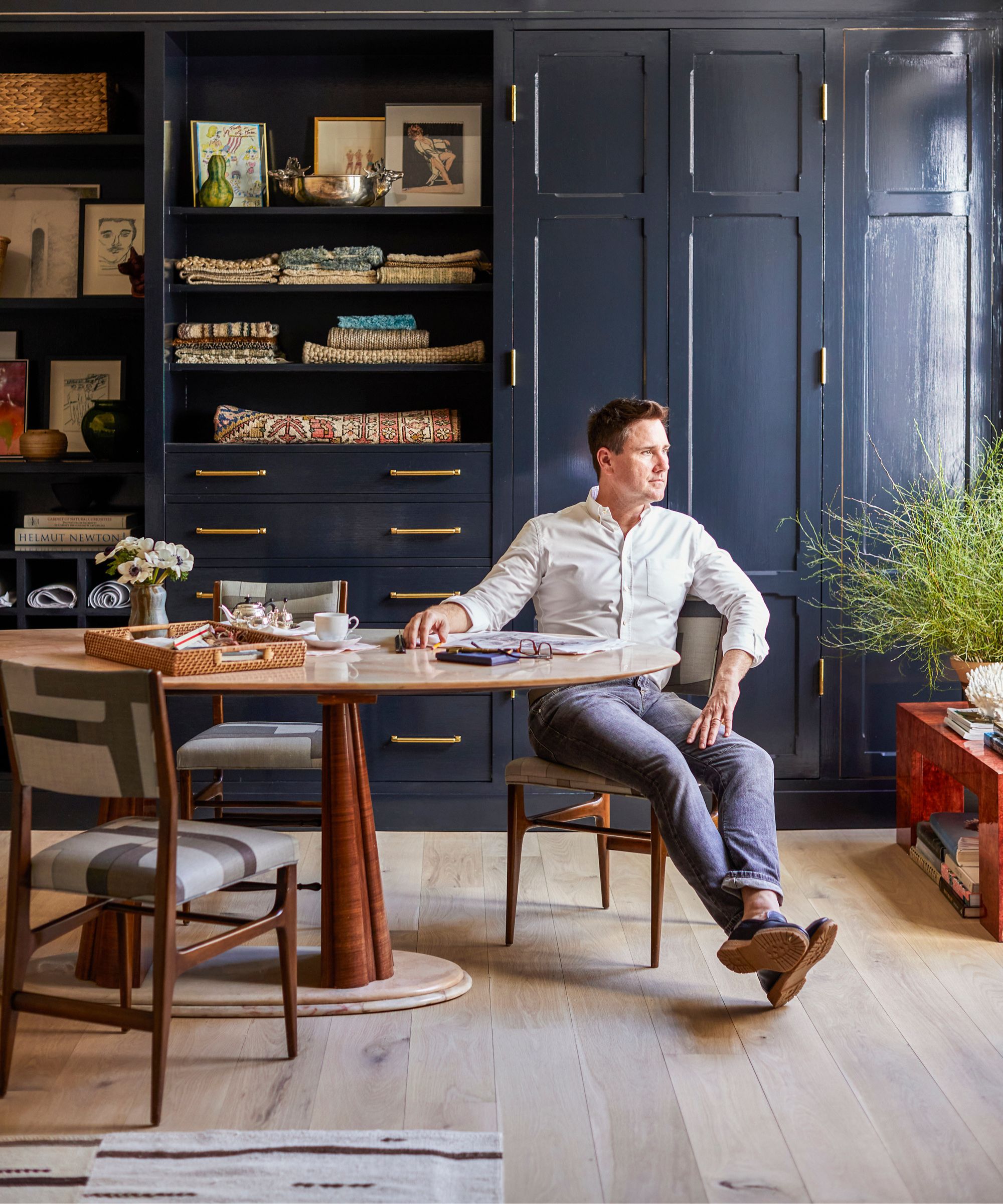 Bryan Graybill sits at home at a table in his studies
