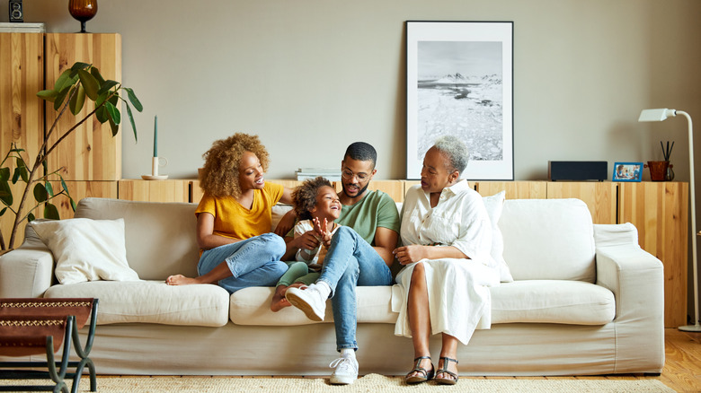 A family sitting in a living room on a sofa