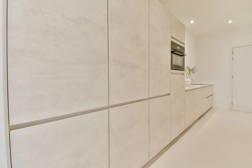 Interior of modern kitchen with white cupboards