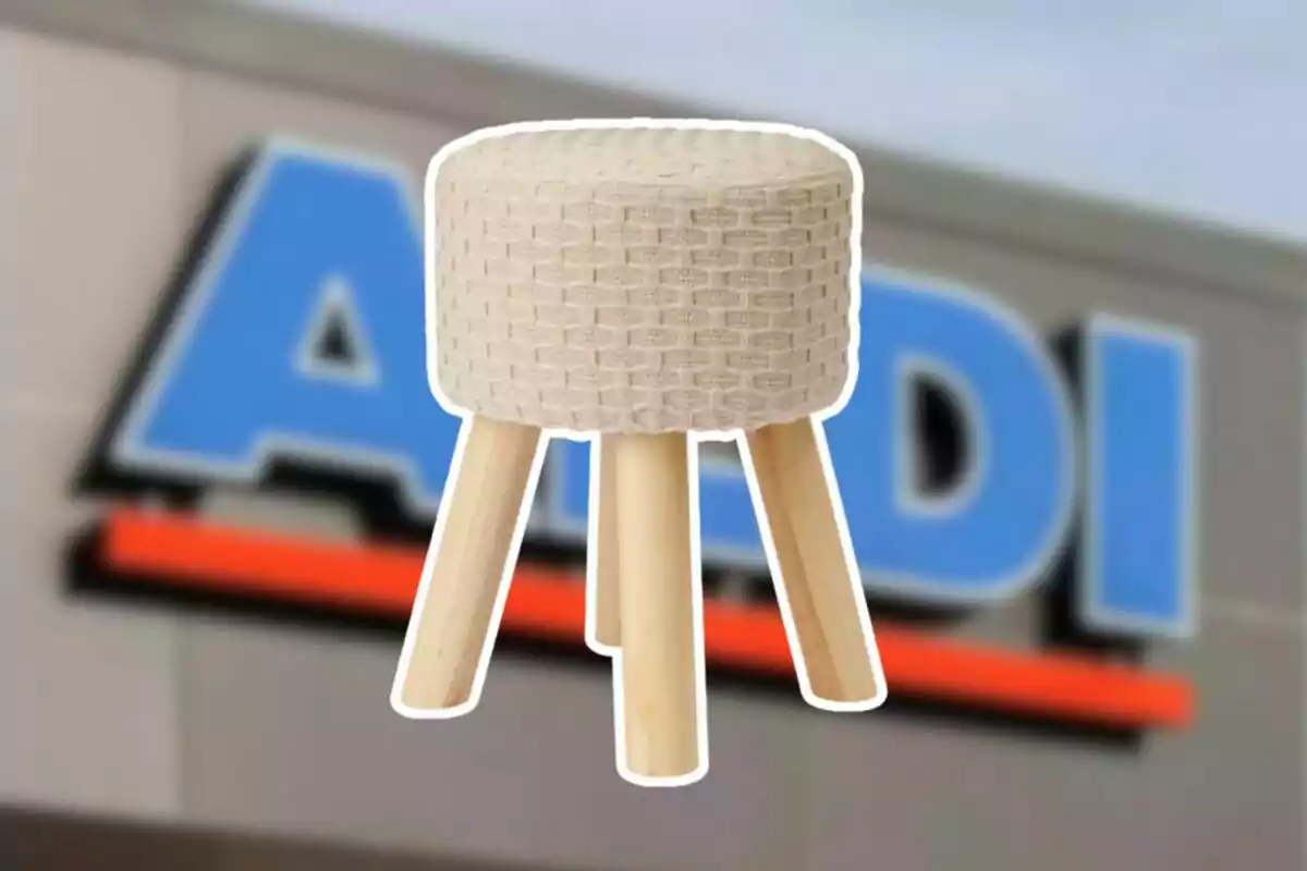Small wooden stool with a beige padded seat in front of a blurry Aldi store shield Small wooden stool with a beige padded seat in front of a blurry Aldi store shield