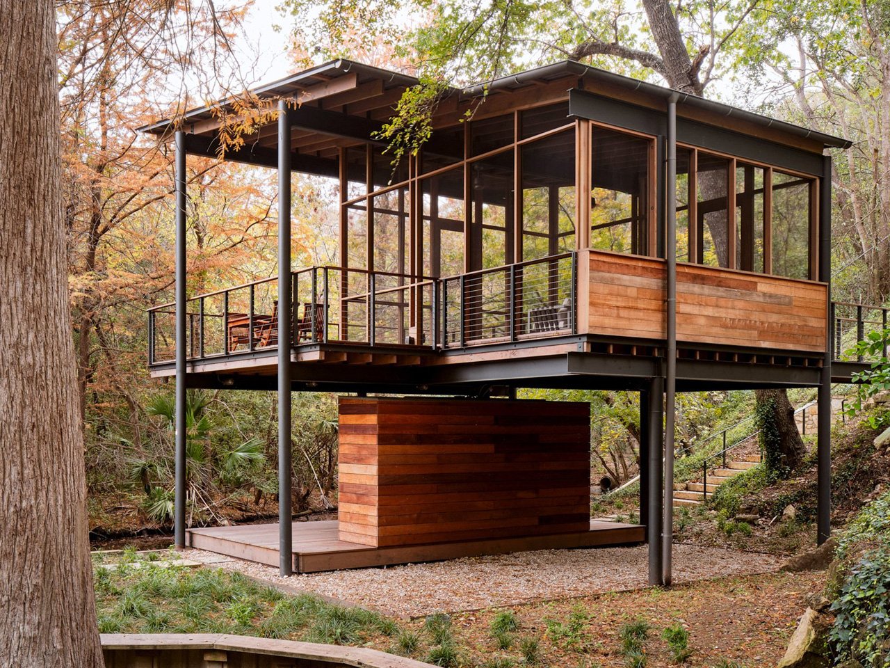 The modern pavilion swims over a stream and offers bird watching and waterfront views