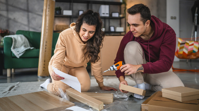 A young couple who moves in a new apartment together together