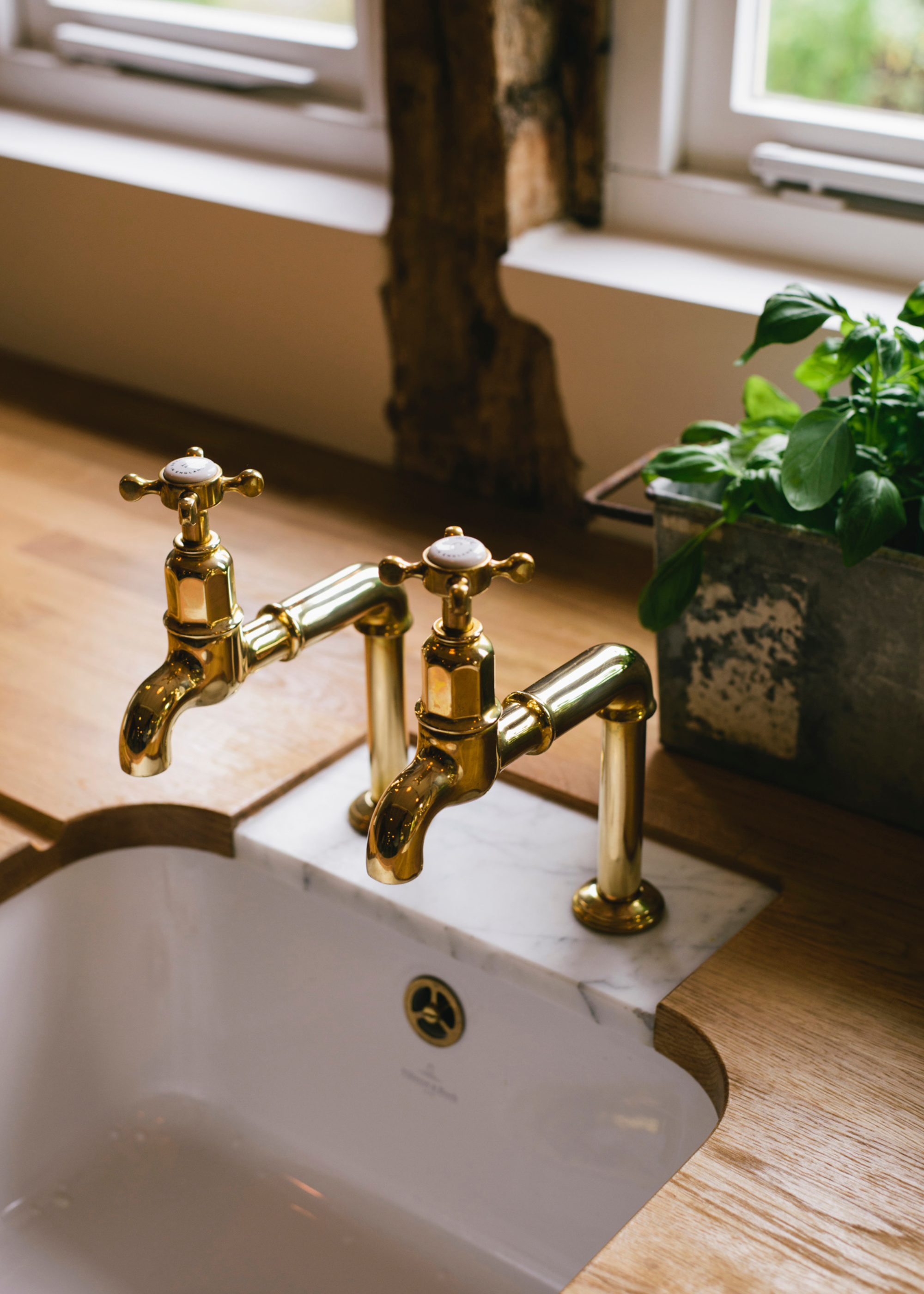 A small marble insert around golden hooks in a wooden worktop