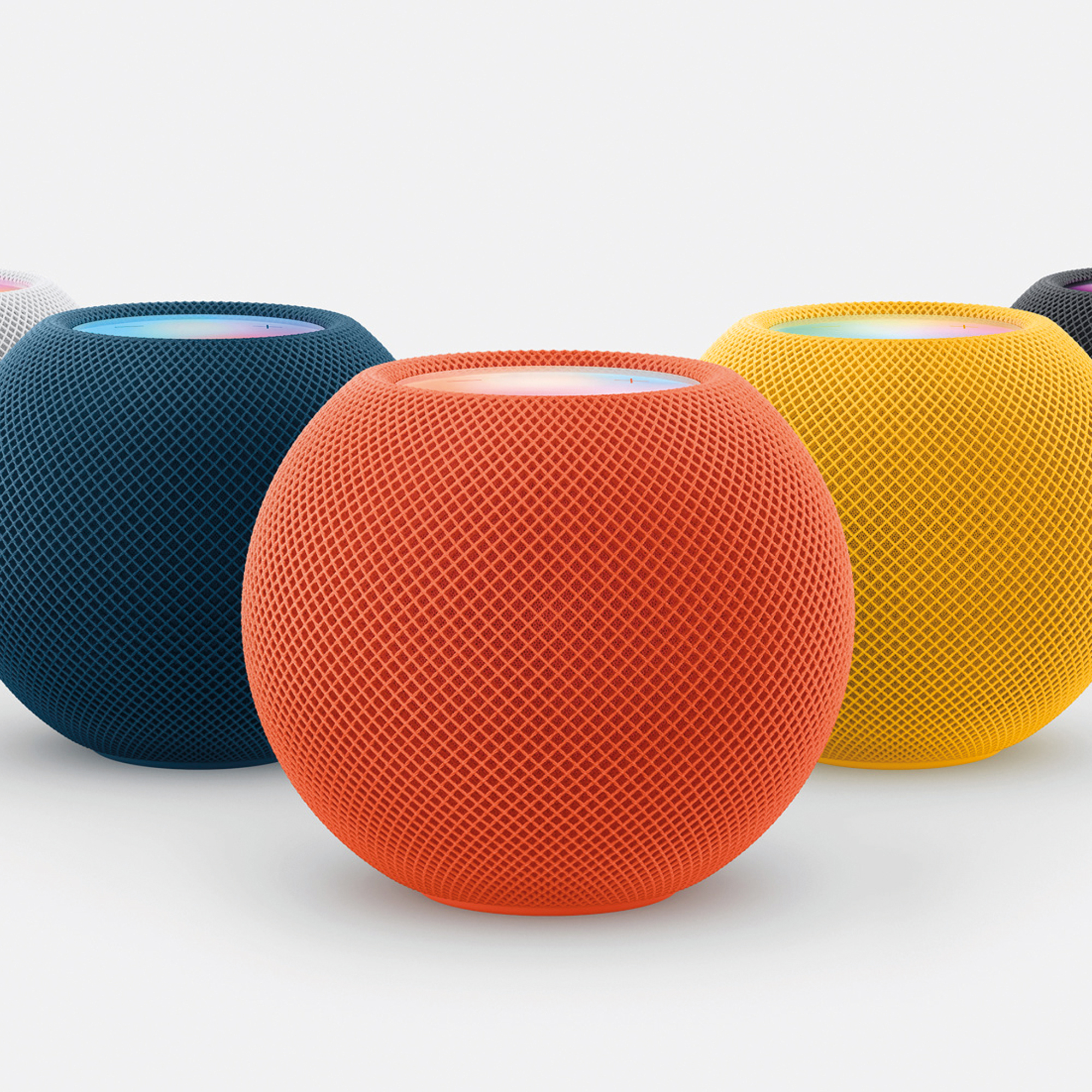 A number of Apple HomePod Minis in different colors