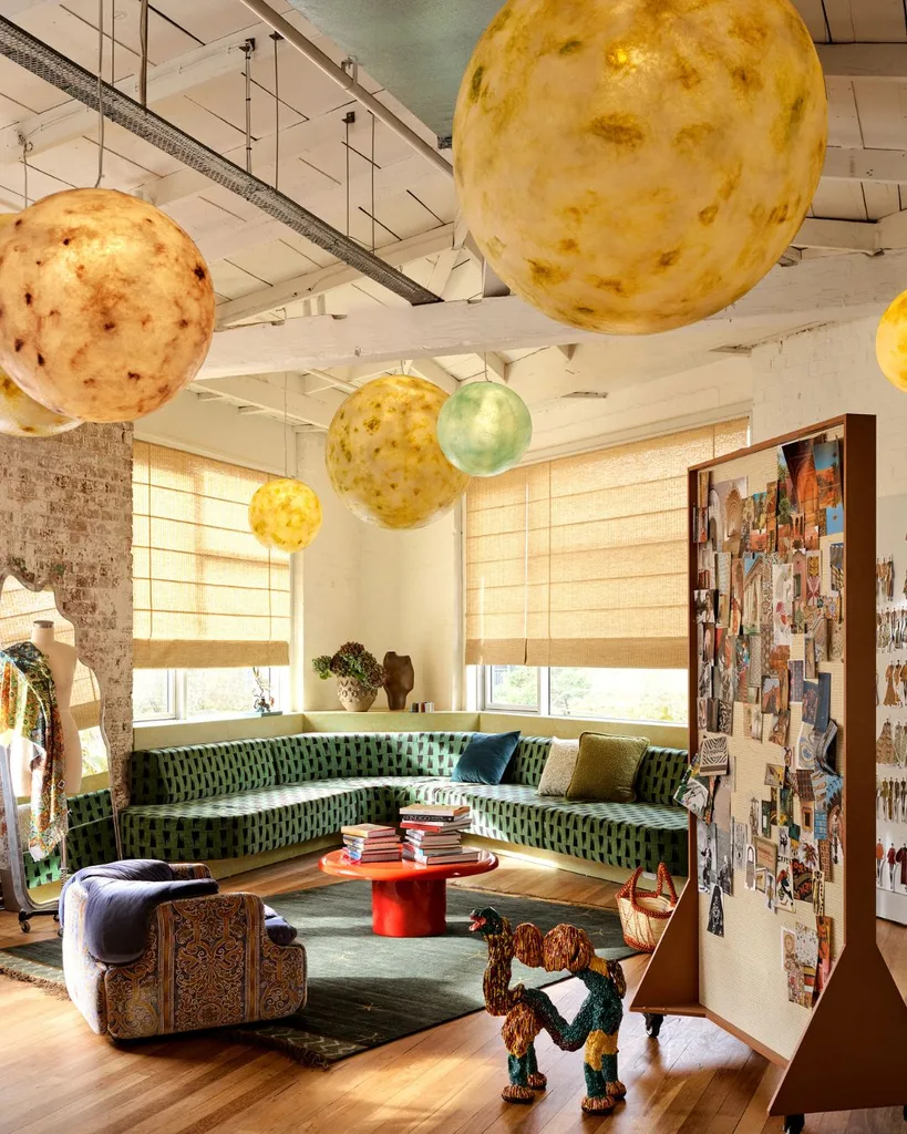 In the new headquarters by Alémais Sydney, round moon-like trailer lights hang into the tip of the wing-shaped floor plan above the built-in seating area. 