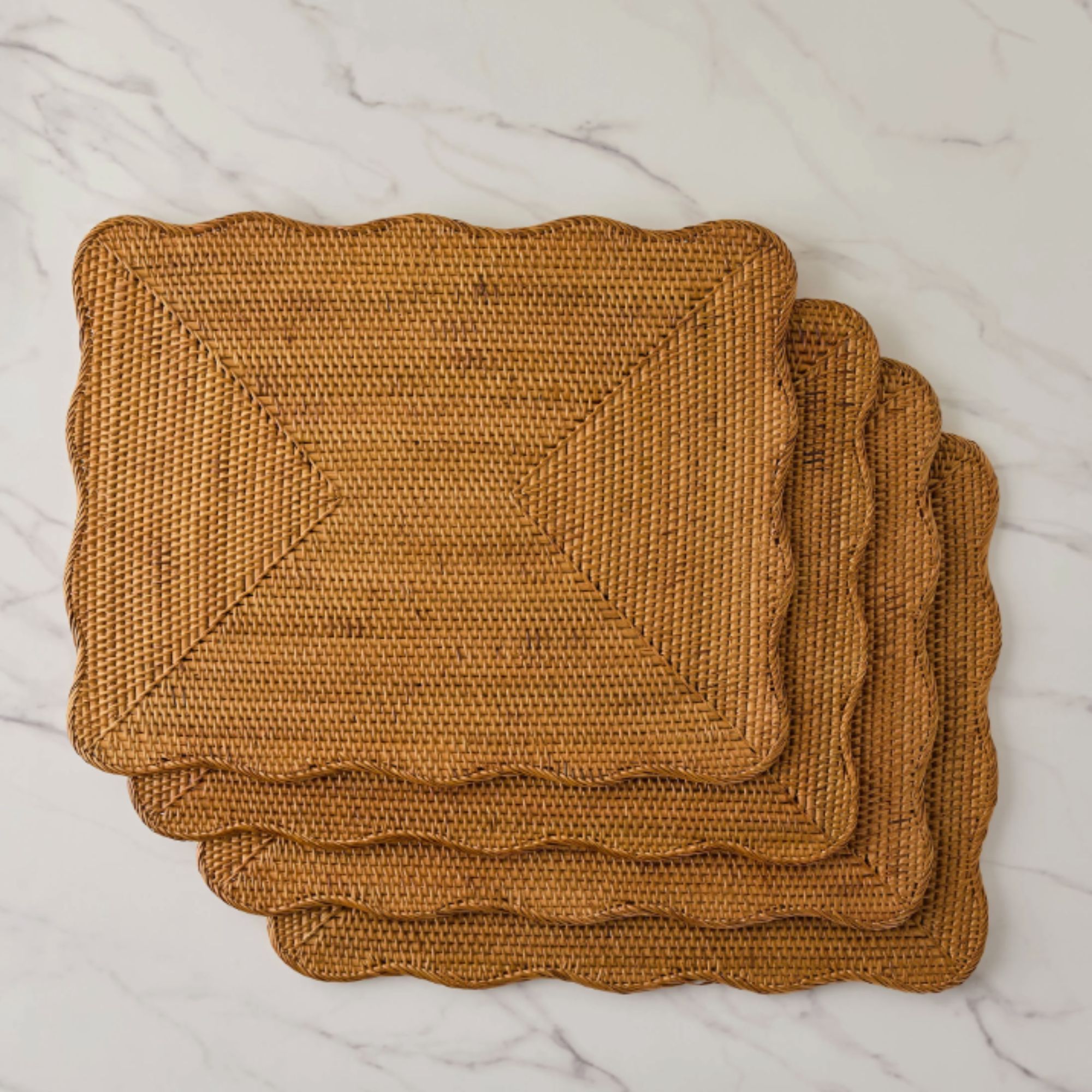 Set of four scalidated rattan rattan placemats on the marble surface