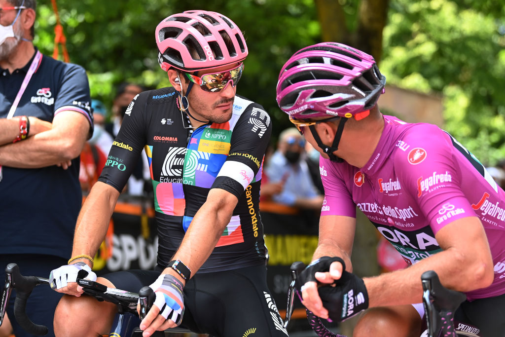 Men talk to each other on bicycles