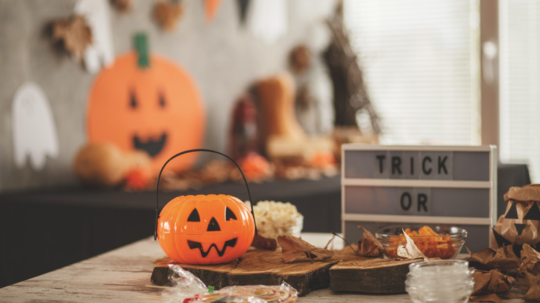 Kitschy Halloween decor and a plastic pumpkin on a modern table