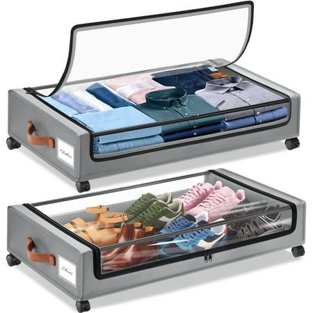 Two gray fabric under bed storage bags, on black plastic wheels with clear lid. Shoes in the bottom pocket and folded shirts in the top pocket. 