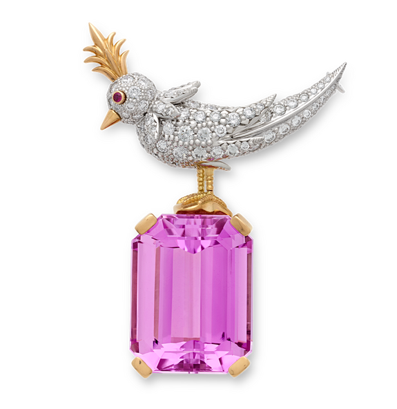 Diamond-studded bird brooch with pink gemstone, gold crest and ruby eye against a black background.