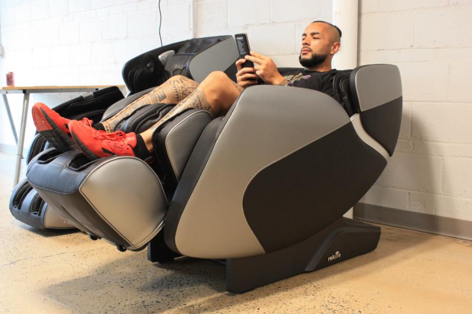 Stephen Sheehan, CPT, CNC leans back in a Relaxe Zero-Gravity Shiatsu massage chair.