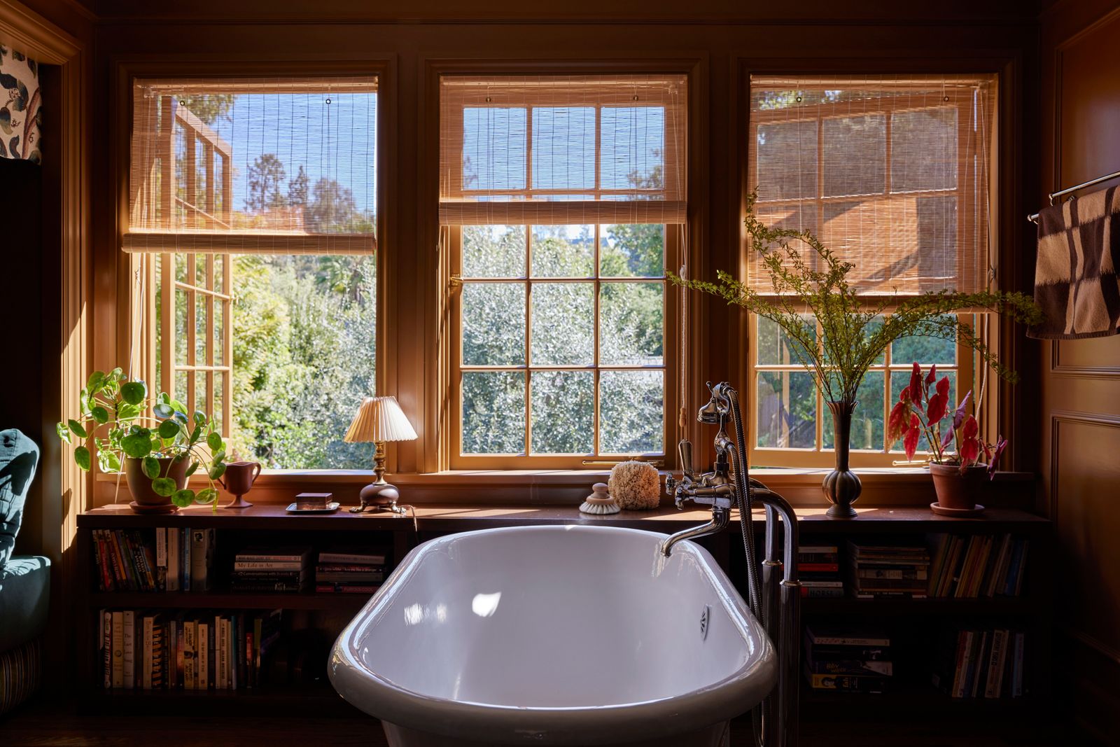 The primary bathroom is the couple's favorite room in the house because it acts as a reading tip and bathing area. The...