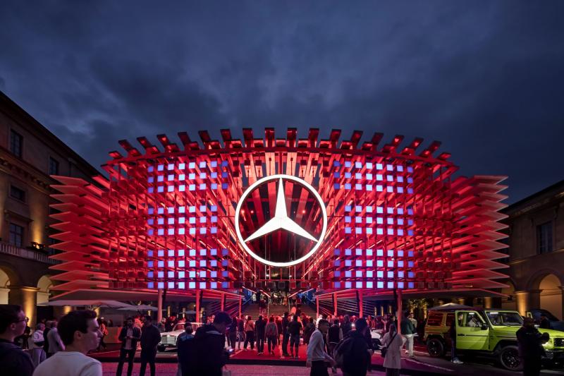 Mercades logo in the center of an illuminated museum entrance covered in red lights simulating the infamous car's grill.